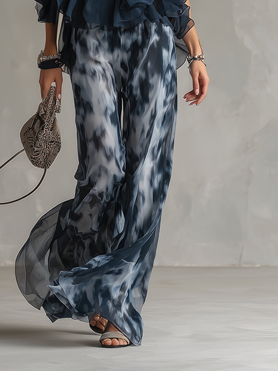 Ludovica - elegante en chiffón con una blusa de cuello alto y pantalones anchos estampados